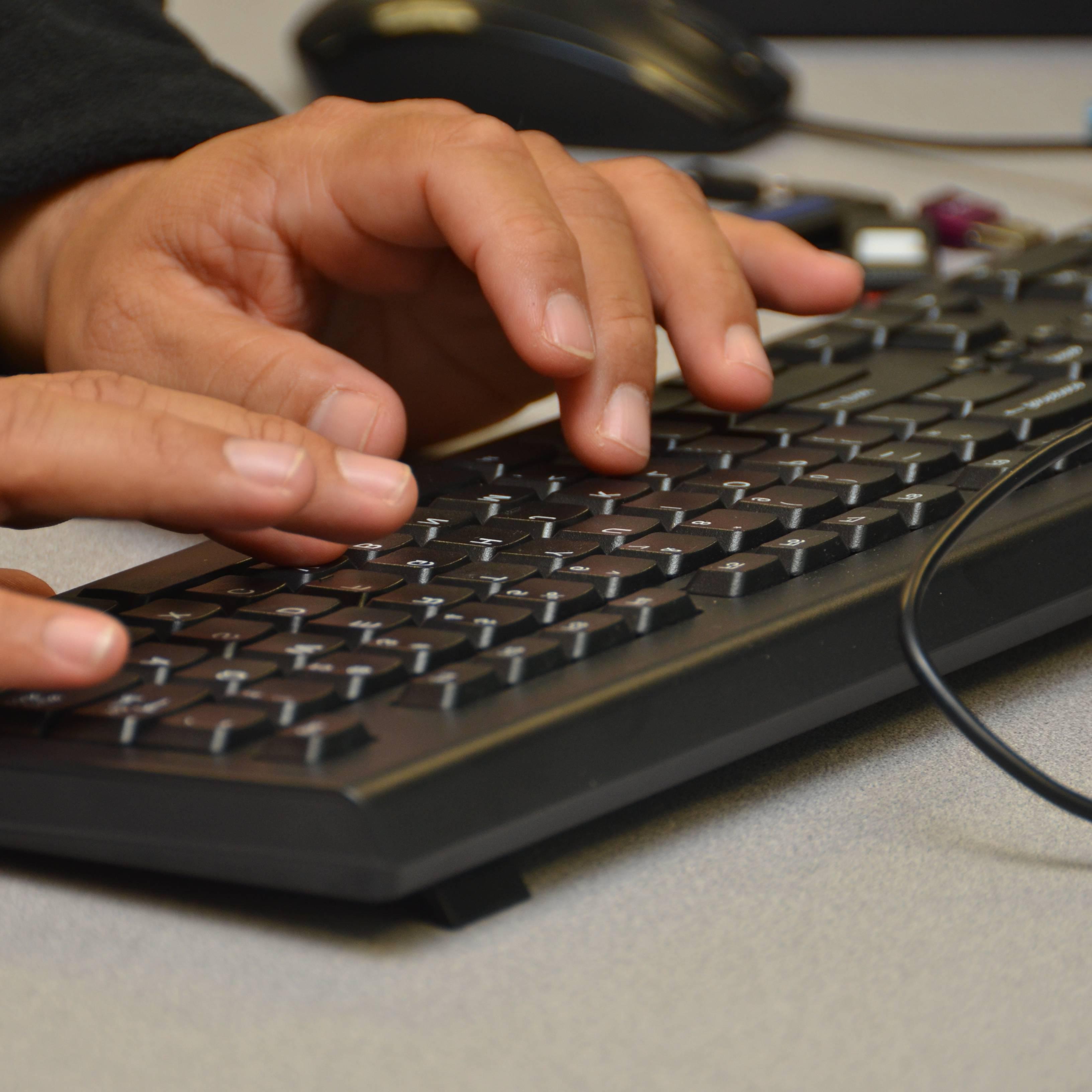 person typing on a keyboard